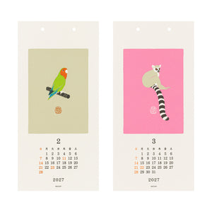 A two-piece wall calendar set for 2027 showing February and March. The left card features a green and orange parrot on a beige background, and the right card features a ring-tailed lemur on a pink background.