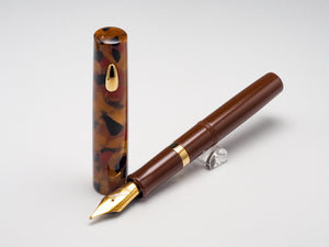A brown fountain pen with a gold nib and trim, shown with its matching cap standing upright on a light gray background.