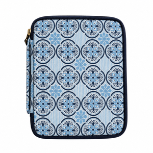 A zippered tablet sleeve featuring a blue and navy geometric tile pattern on a light blue background, with a gold zipper pull.