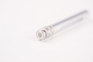 A close-up of a silver metal pen tip with a textured adjustment ring and a circular logo emblem, set against a clean white background.