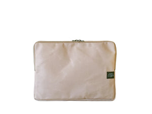 Beige pouch with a green label on a white background