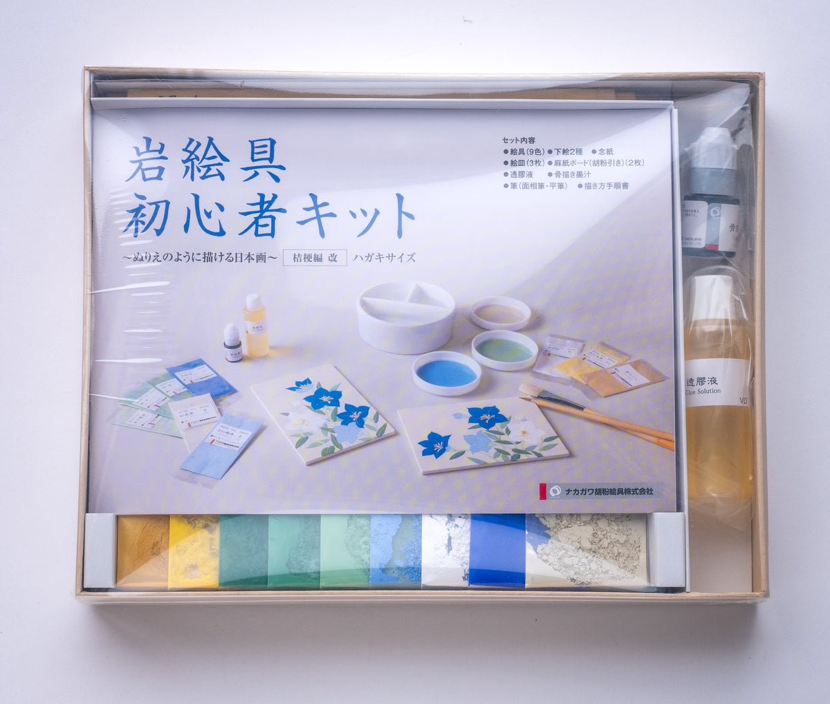 Art supply kit with materials and instructions on a white background