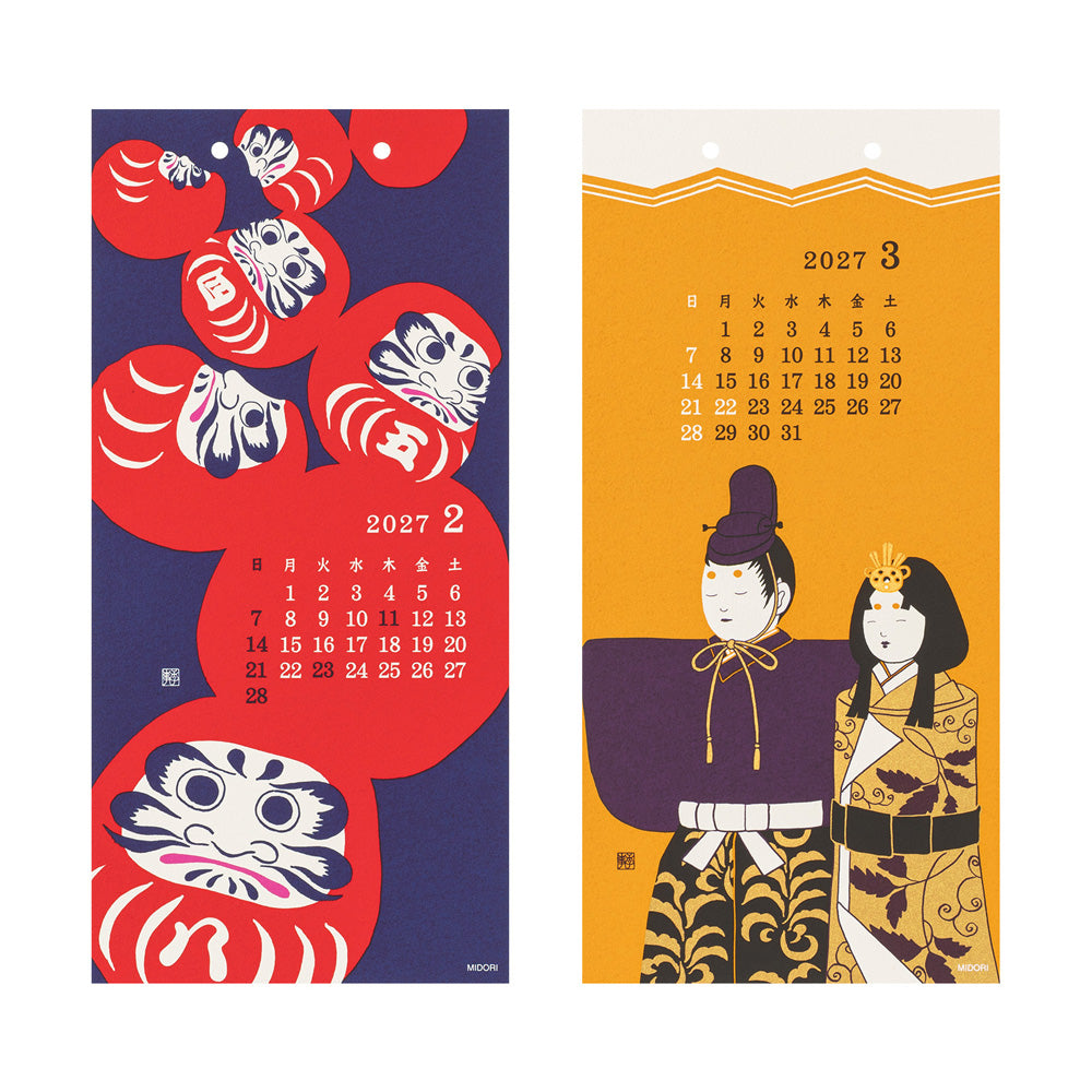 Two Japanese wall calendars shown side by side on a white background. The left calendar features red Daruma doll illustrations on a dark blue background with a February 2027 calendar grid.