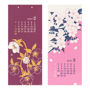 Two vertical hanging calendar pages with floral illustrations. The left page is dark plum purple with white and yellow flowers and a 2027 February calendar grid.