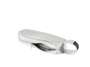 A light gray fabric pouch with a zippered main compartment and a small black label on the side, nomado store.