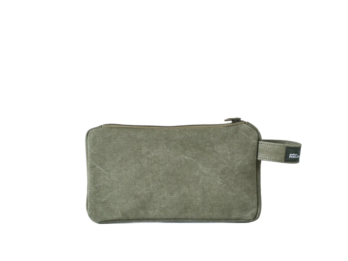 An olive green canvas zippered pouch with a matching wrist strap and a small black brand tag, photographed on a clean white background.
