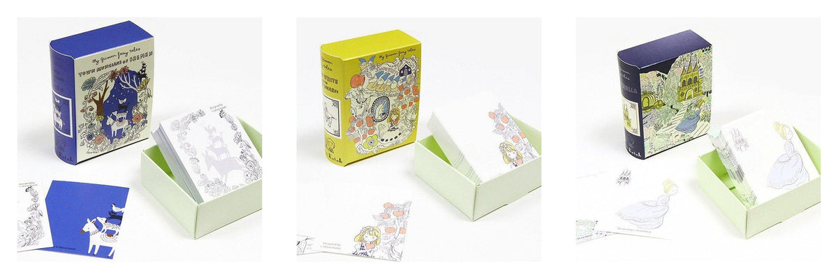 Three illustrated product boxes shown open on a white background, each containing small printed cards or packets. The boxes feature fantasy-style artwork in blue, yellow, and dark purple tones, with pale green inner packaging visible.