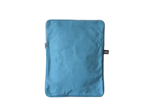 A blue fabric sleeve or pouch with rounded corners, standing upright against a plain off-white background. A small black fabric tag is visible on the right side.