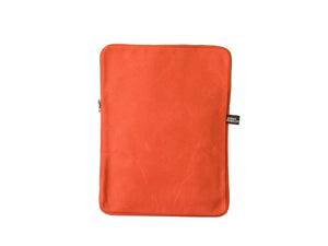 A bright orange fabric tablet sleeve or pouch with rounded corners, standing upright against a clean white background. A small black brand tag is visible on the right side.