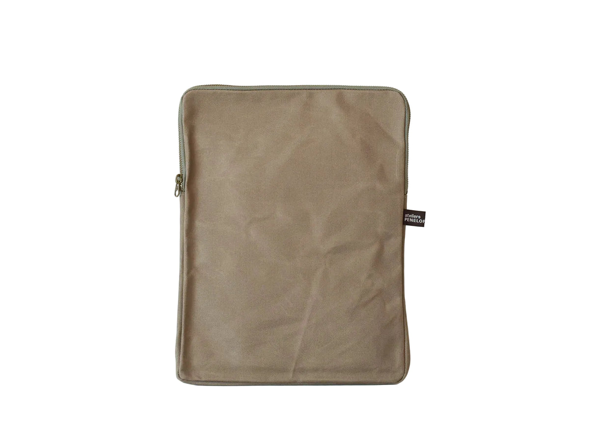 A rectangular taupe-brown fabric pouch or sleeve with rounded corners, a zipper closure, and a small black brand tag on the right side, photographed against a plain white background.