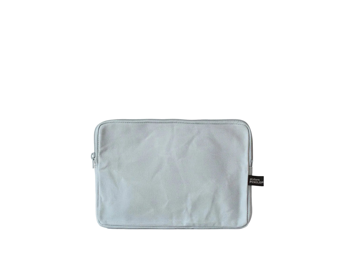 A light gray fabric pouch or sleeve with a zipper closure and a small black brand tag on the right side, displayed against a clean white background.