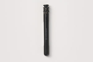 A black cylindrical Klim VISION baton-style accessory with white printed branding, shown vertically against a light gray background.