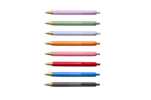 Eight retractable ballpoint pens in pastel and neutral colors are arranged vertically on a light gray background. The pen colors include lavender, mint green, pale blue, orange, pink, red, royal blue, and dark gray.