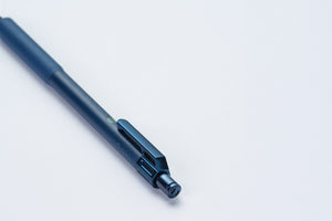 A dark metallic blue retractable pen with a sleek clip, shown diagonally on a clean white background.