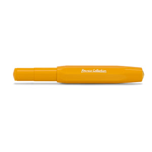 A bright yellow-orange pen with 'Kamusco Collection' printed in white script on the side, shown against a plain white background.