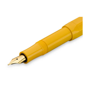 A close-up of a yellow fountain pen nib and barrel section on a clean white background.