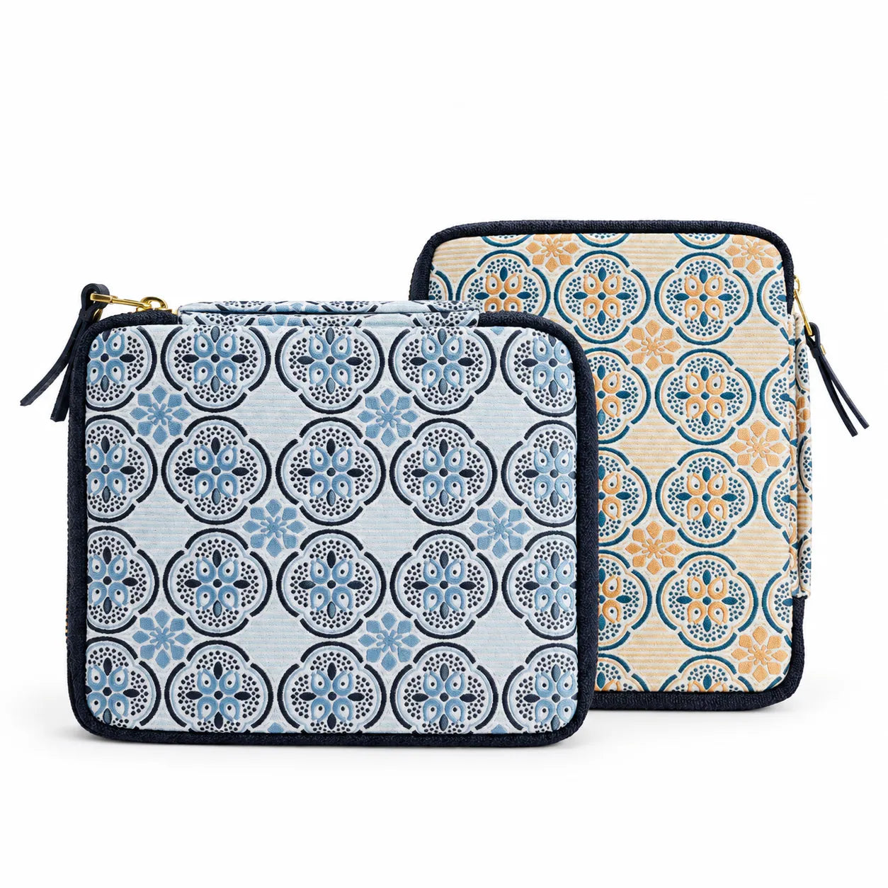 Two zippered pouches with a decorative tile pattern, shown on a plain white background. One pouch has a light blue and navy pattern, and the other has a beige, blue, and orange pattern.