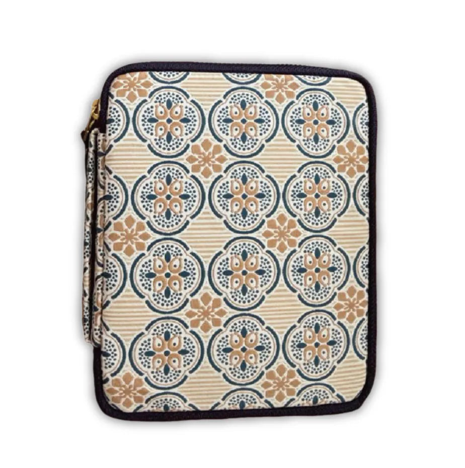 A zippered sleeve or pouch with a repeating ornate medallion pattern in beige, navy blue, and tan, finished with a black zipper trim.