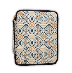 A zippered sleeve or pouch with a repeating ornate medallion pattern in beige, navy blue, and tan, finished with a black zipper trim.