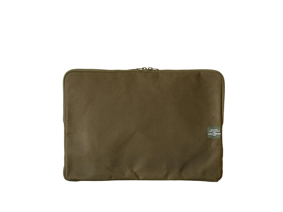 Green fabric pouch with a patch on a white background