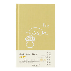 A book-style 2027 diary with a pale yellow cover and cream lower section, featuring simple line-art illustrations and Japanese text. The product is photographed against a plain white background.