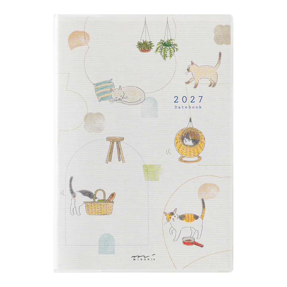 A 2027 daily planner notebook with a white textured cover decorated with whimsical cat illustrations and pastel doodles, shown against a plain white background.