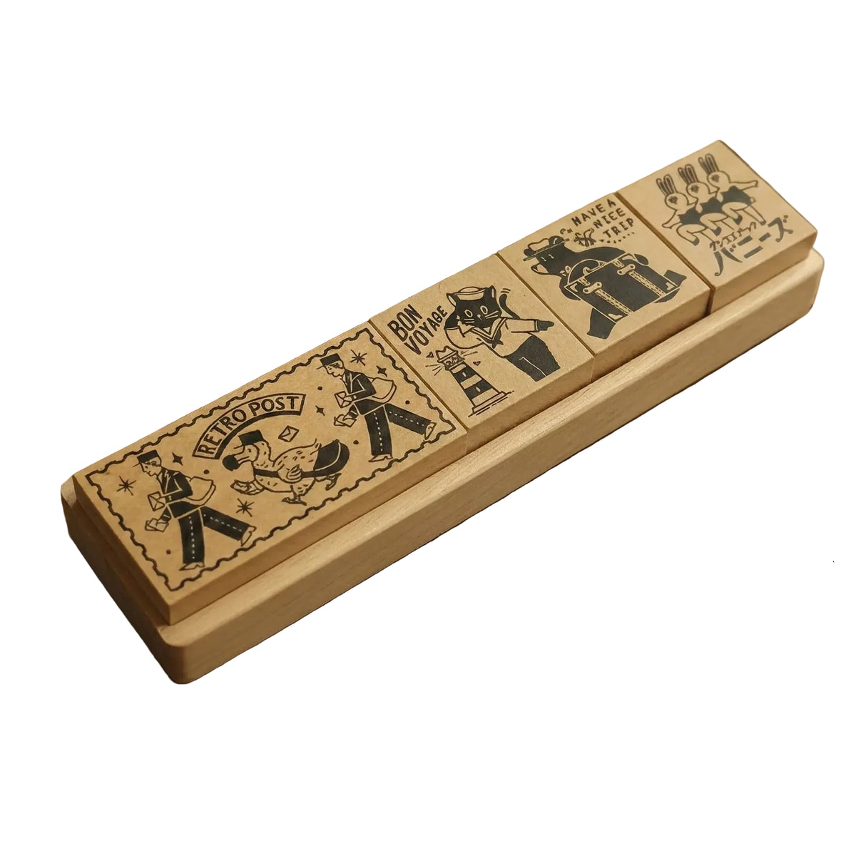 Set of vintage-style stamps in a wooden holder with stamps and an inkwell in the background.