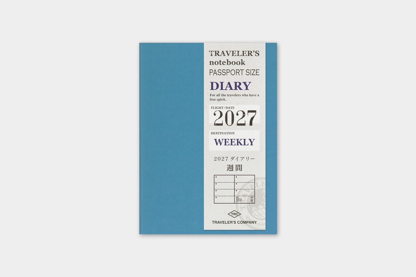 A 2027 weekly traveler's notebook by Traveler's Company, featuring a slate blue cover with a white vertical panel detailing the text and year.