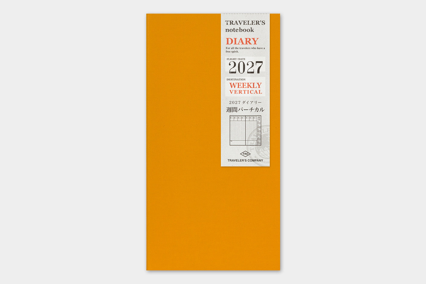 An orange vertical weekly planner notebook with a white paper cover label on the front, featuring the text 'TRAVELER'S notebook DIARY 2027 WEEKLY VERTICAL' and the Travellers Company logo.