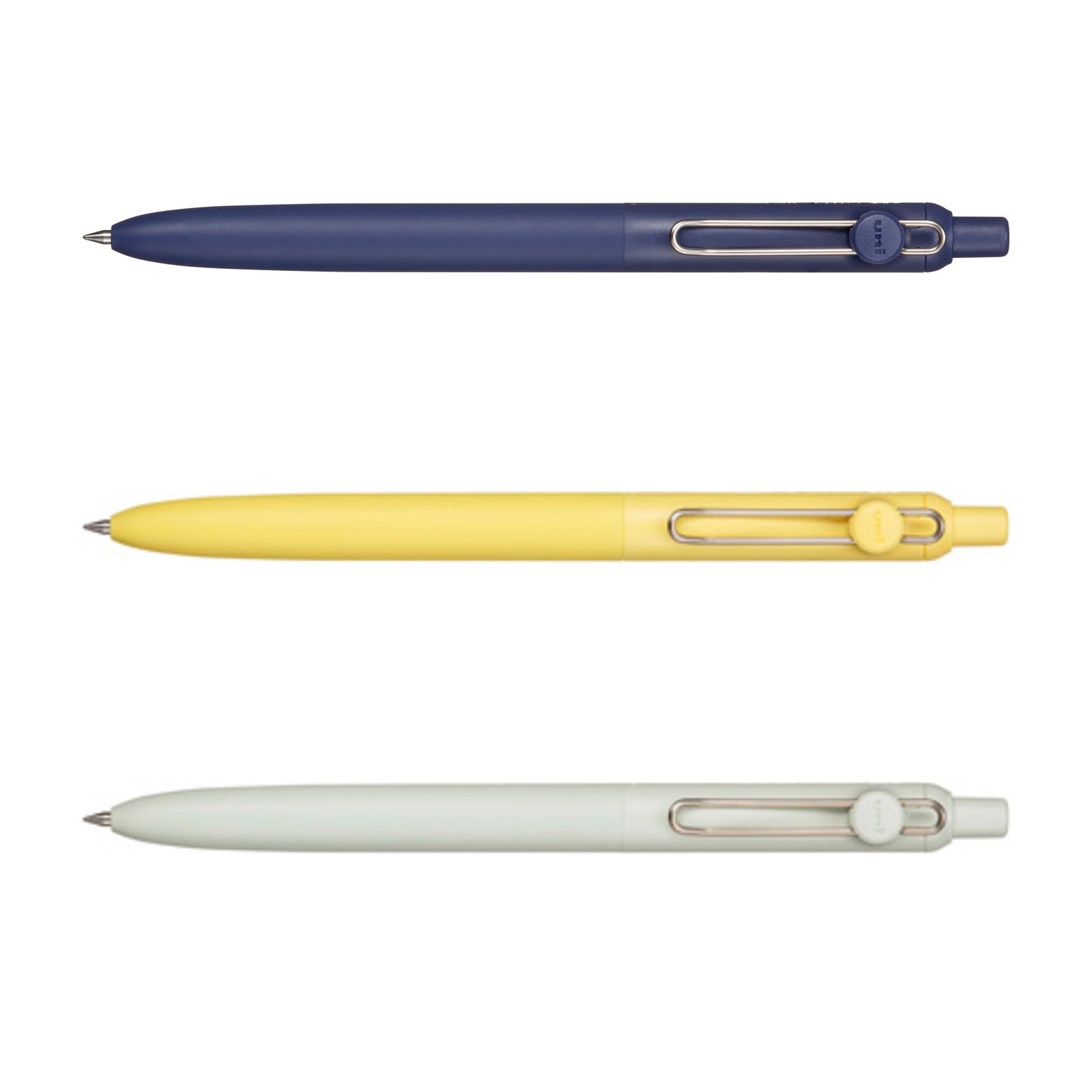 Three retractable ballpoint pens shown horizontally on a white background, in navy blue, pale yellow, and off-white. Each pen has a metal clip and a small circular logo badge on the cap.
