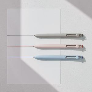 Three pens in different colors on a light gray background